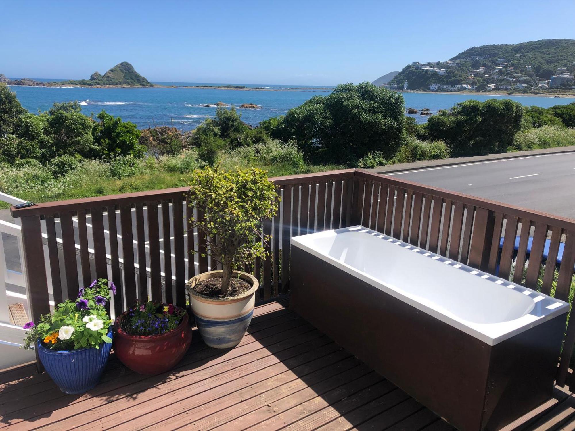Seafront Haven In Island Bay With Deck, Outdoor Bath, And Parking